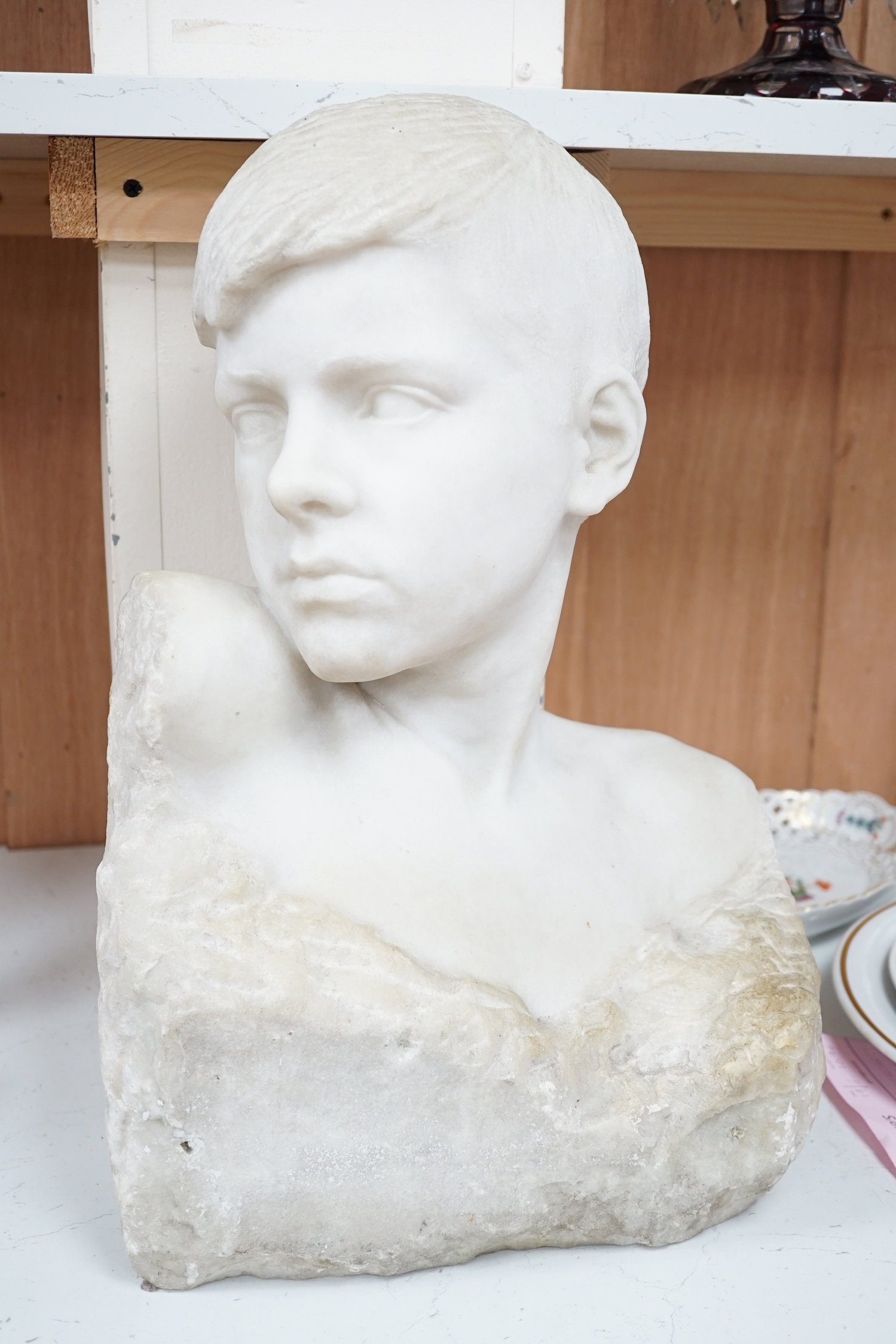 A carved Carrara marble portrait bust of a youth, unsigned, 46cm